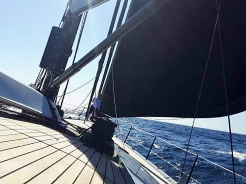 View along the deck of a sailing yacht crossing the open sea