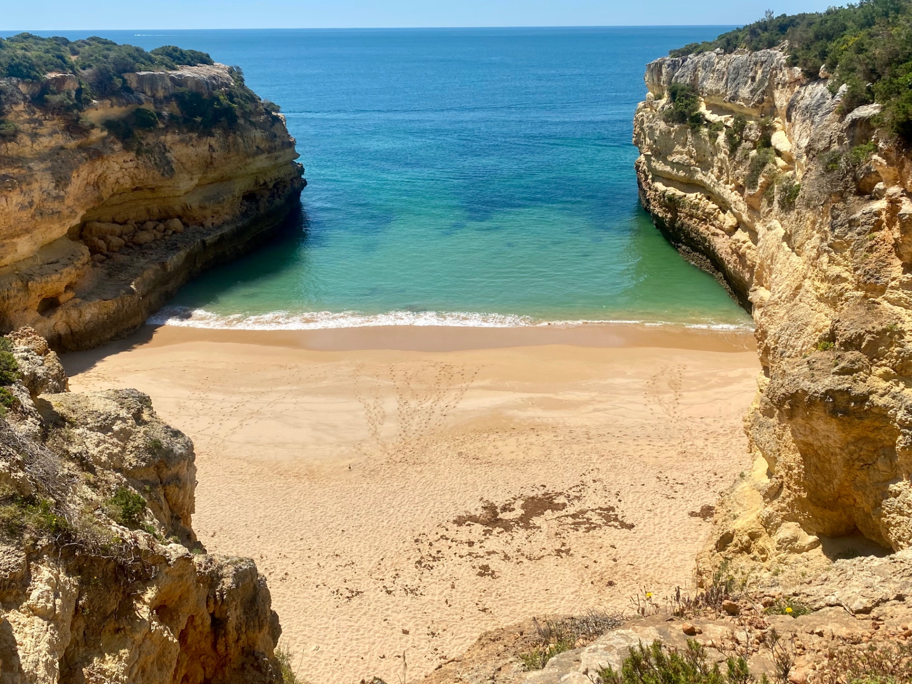 Hidden Algarve cove in Portugal with golden cliffs and turquoise water