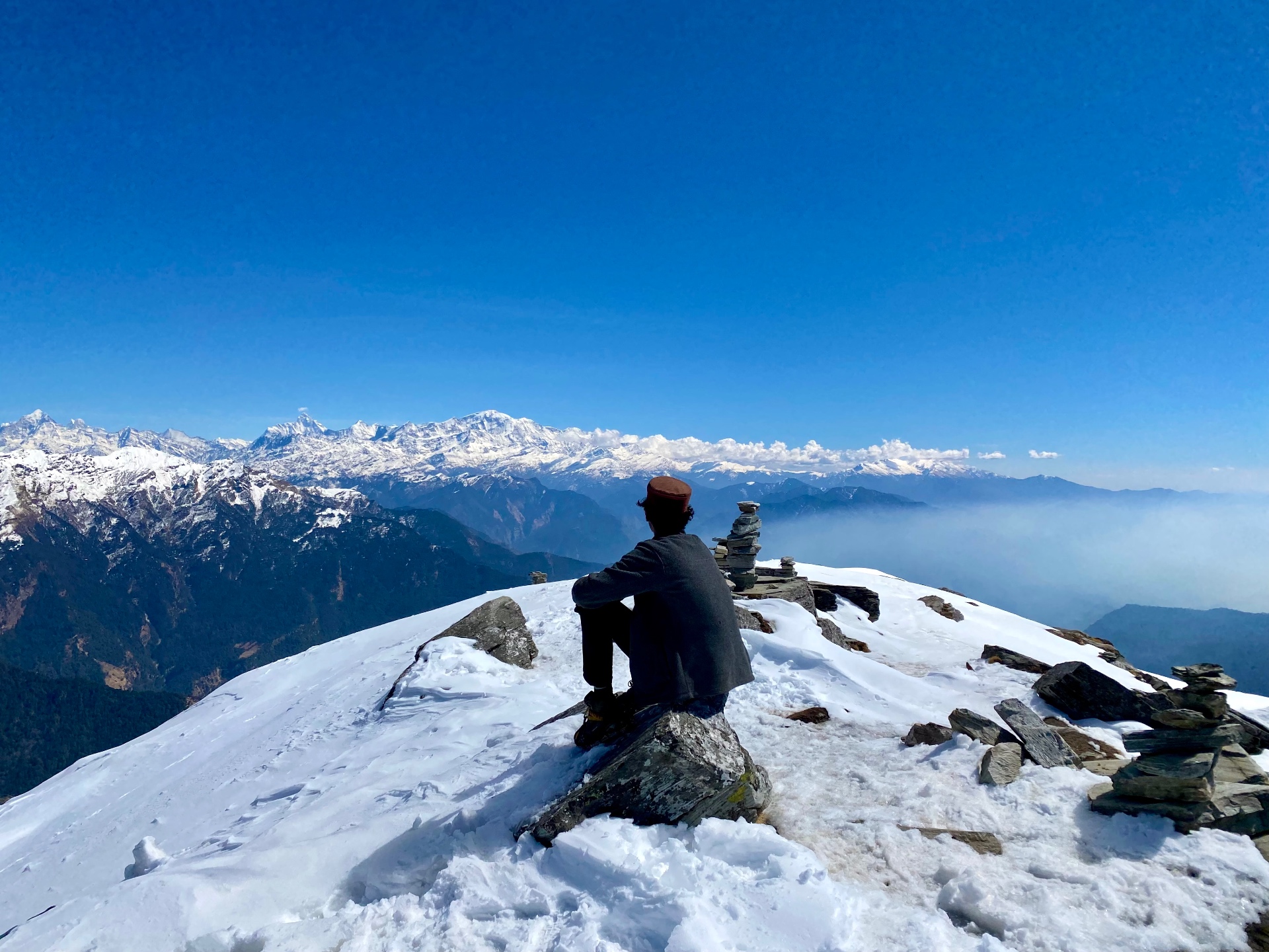 Sitting on a snowy Himalayan summit looking out over endless peaks, India
